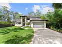 Beautiful two-story home featuring white painted brick and a well-manicured lawn at 13562 S Lake Mary Jane Rd, Orlando, FL 32832