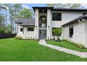 Striking two-story home features a modern gray front door and lush green lawn at 13562 S Lake Mary Jane Rd, Orlando, FL 32832