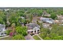 Aerial view showcasing the home's expansive lot, mature trees, and surrounding neighborhood at 690 E Church St, Bartow, FL 33830