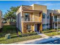 Modern two-story home with a stone accent wall and balcony at 7672 Amazonas St, Kissimmee, FL 34747