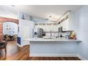 Spacious kitchen with stainless steel appliances, brick archway, and marble island at 830 Grand Hughey Ct, Apopka, FL 32712