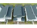 Aerial view of modern townhomes, showcasing roof lines and private pools at 9312 Sommerset Hills Dr, Davenport, FL 33896