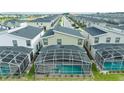 Aerial view of townhome featuring a screened pool and neighborhood at 9312 Sommerset Hills Dr, Davenport, FL 33896