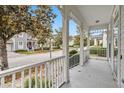 Inviting porch with white railings offers a pleasant view of the street and neighborhood at 1013 Maiden Ter, Celebration, FL 34747