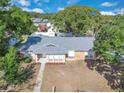 Aerial view showcasing the home's layout, roof, and surrounding landscape in a peaceful neighborhood setting at 1030 Gran Paseo Dr, Orlando, FL 32825