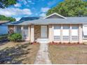 Attractive front entrance highlighting the brick accents, white door, and small landscaping details at 1030 Gran Paseo Dr, Orlando, FL 32825