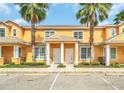 Inviting two-story townhome featuring a landscaped yard and convenient parking at 17349 Serenidad Blvd, Clermont, FL 34714