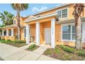 Well-maintained townhouse with a tidy landscape, featuring palm trees at 17349 Serenidad Blvd, Clermont, FL 34714