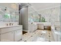 A luxurious bathroom boasts marble walls and floors, mirrored wall, dual sinks and modern lighting at 1761 Legion Dr, Winter Park, FL 32789