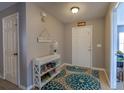 Inviting entryway with decorative console table and teal patterned rug at 177 Bristol Forest Trl, Sanford, FL 32771
