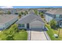 Aerial view of a well-kept home with a lush green lawn and tidy landscaping in a suburban community at 1866 Cassidy Knoll Dr, Kissimmee, FL 34744