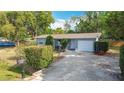 Quaint single-story home showcasing a brick driveway and mature landscaping at 1901 Rose Blvd, Orlando, FL 32839