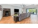 Spacious living room features a large sectional sofa, wood floors, and access to the outdoor patio at 2167 Pearl Cider St, Orlando, FL 32824