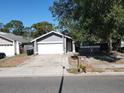 Charming single-story home with a well-maintained front yard, attached garage, and inviting curb appeal at 2212 Atrium Cir, Orlando, FL 32808