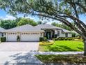 Beautiful single-story home with a three car garage and meticulously landscaped front yard at 224 Bluestone Pl, Casselberry, FL 32707