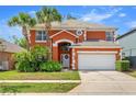Charming two-story home featuring an attached two-car garage and well-manicured landscaping at 2769 Lido Key Dr, Kissimmee, FL 34747