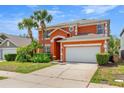 Charming two-story home featuring an attached two-car garage and mature landscaping at 2769 Lido Key Dr, Kissimmee, FL 34747