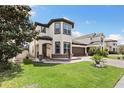 Charming two-story home boasts a well-manicured lawn, stone accents, and a welcoming arched entryway at 3138 Twin Shore Ln, Orlando, FL 32824