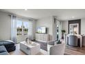 Bright, open living space with dining area, stylish furniture, and modern decor at 3727 Bluethread Way, Poinciana, FL 34759