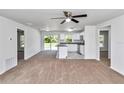 Bright living space with carpet, ceiling fan, flowing into the kitchen with stainless steel appliances at 3914 Sw 161St Loop, Ocala, FL 34473