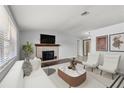 Bright living room featuring a brick fireplace, stylish furniture, and modern decor at 4070 Mcneil Rd, Apopka, FL 32703