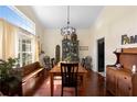 Bright dining room featuring wood floors, a large window, and a vintage china cabinet at 4199 Conway Place Cir, Orlando, FL 32812