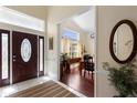 Inviting foyer with tile flooring, leading to a dining area with wood floors and large windows at 4199 Conway Place Cir, Orlando, FL 32812