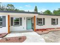 Close-up of a home's bright blue door and well-maintained landscaping at 451 E 5Th St, Chuluota, FL 32766