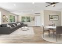 Open-concept living area with large windows and a modern aesthetic at 451 E 5Th St, Chuluota, FL 32766