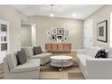 Bright living room featuring modern decor, light wood floors, and ample seating at 451 E 5Th St, Chuluota, FL 32766
