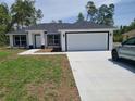 Beautiful single-story home featuring a clean two car garage, driveway and well-kept lawn at 4529 Sw 169Th Pl, Ocala, FL 34473