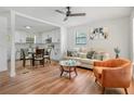Bright living room featuring hardwood floors, recessed lighting, and an open layout to the kitchen and dining area at 4922 Huppel Ave, Orlando, FL 32811