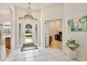 Bright foyer featuring tile flooring, glass-paneled front door, and an open view into the office at 525 Hebrides Ct, Apopka, FL 32712