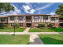 Charming condo with Tudor-style architecture, beautiful landscaping, and inviting walkway to the front entrance at 5325 Hansel Ave # E-15, Orlando, FL 32809