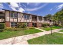 Inviting Tudor-style condo with well-manicured lawn and beautiful front walkway and manicured plants at 5325 Hansel Ave # E-15, Orlando, FL 32809