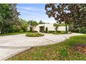 Beautiful circular driveway and landscaping leading up to a stunning modern home at 608 E Club Cir, Longwood, FL 32779