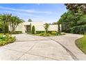Sprawling driveway and manicured landscaping accent this modern home's exterior at 608 E Club Cir, Longwood, FL 32779