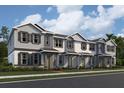 Charming townhomes showcasing a neutral color palette, covered entryways, and manicured landscaping along the front at 624 Pothos St, Apopka, FL 32703