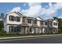 Charming townhomes showcasing a neutral color palette, covered entryways, and manicured landscaping along the front at 624 Pothos St, Apopka, FL 32703