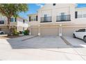 A good view of the townhouse and garages, plus balconies above and landscaping along the front at 6434 S Goldenrod Rd # 17B, Orlando, FL 32822