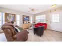 Bright living room with tile flooring, fan, comfortable seating, and a view to the outside at 645 Upperriver Ct, Orlando, FL 32828