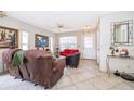 Bright living room with tile flooring, fan, comfortable seating, and a view to the outside at 645 Upperriver Ct, Orlando, FL 32828