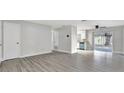 Open-concept living area with modern flooring that connects seamlessly to the adjacent kitchen at 7507 Duo Lakes Dr, Orlando, FL 32810