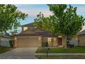 Charming two-story home featuring manicured lawn, mature trees, and attached two-car garage at 802 Pickfair Ter, Lake Mary, FL 32746