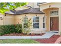 Close up shot showing front entrance of home featuring manicured shrubbery and a sidewalk at 802 Pickfair Ter, Lake Mary, FL 32746