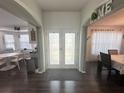 Open foyer with wood floors leading to a dining room and kitchen, providing a spacious and welcoming atmosphere at 8398 Split Creek Cir, Lakeland, FL 33809