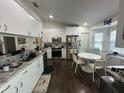 Bright kitchen with white cabinets, stainless steel appliances, and a cozy breakfast nook near a window at 8398 Split Creek Cir, Lakeland, FL 33809