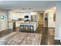 Bright, spacious kitchen with center island, stainless appliances and dark hardwood floors at 8484 Sandberry Blvd, Orlando, FL 32819