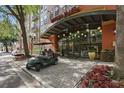Charming entrance to Uptown Place, with hanging sphere lights, a covered walkway, and nearby parking at 911 N Orange Ave # 409, Orlando, FL 32801