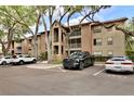 Complex exterior with lush trees and ample parking at 956 Salt Pond Pl # 207, Altamonte Springs, FL 32714
